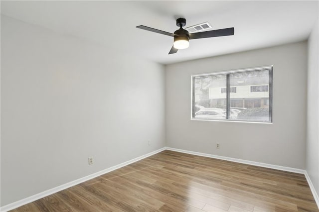 empty room with ceiling fan and light wood-type flooring