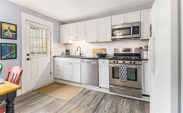 135 E Hill St Unit 24, Decatur, GA 30030 - kitchen featuring appliances with stainless steel finishes, wood finished floors, and white cabinets