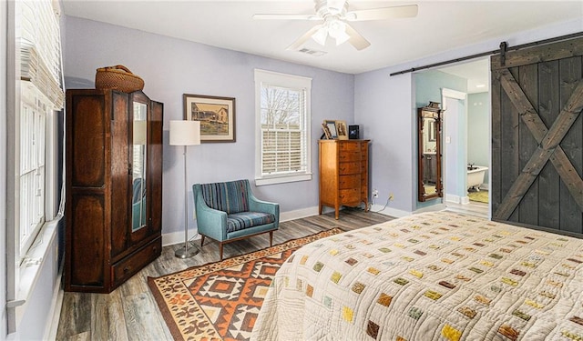 135 E Hill St Unit 24, Decatur, GA 30030 - bedroom featuring wood finished floors, a barn door, and a ceiling fan