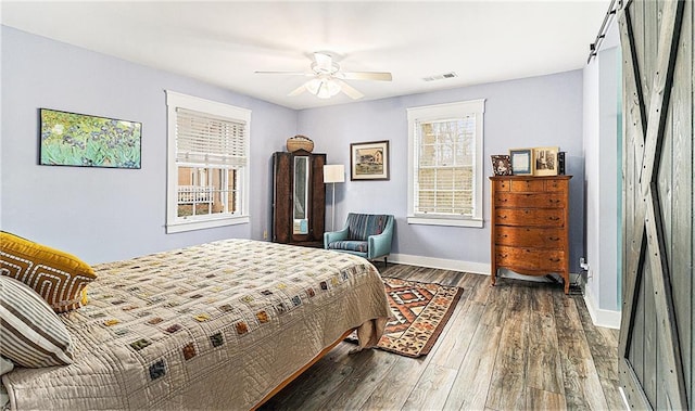 135 E Hill St Unit 24, Decatur, GA 30030 - bedroom featuring wood finished floors, a ceiling fan, and a barn door