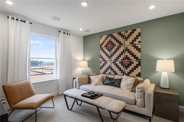 living room featuring carpet and plenty of natural light