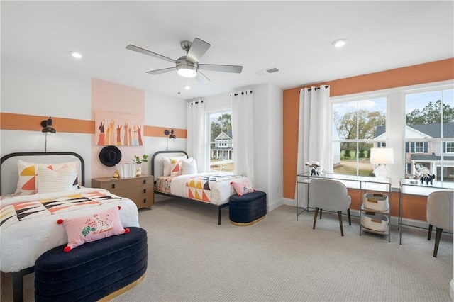 bedroom with ceiling fan and light carpet