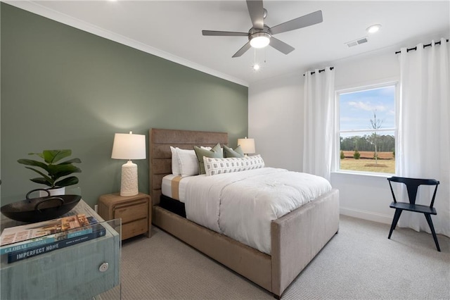 carpeted bedroom featuring ceiling fan and ornamental molding