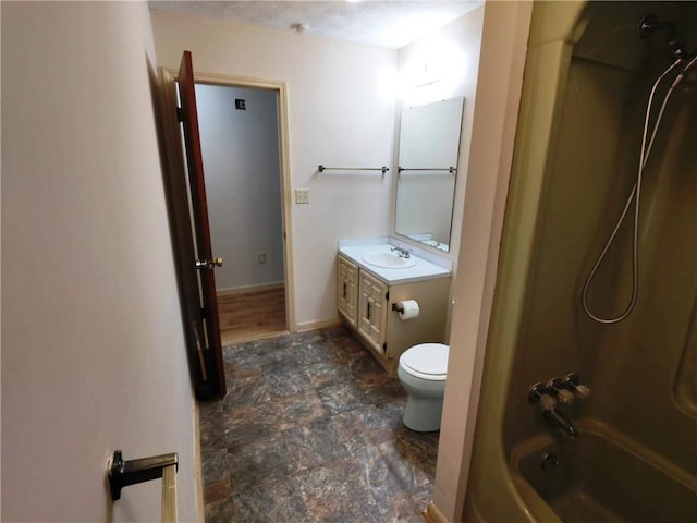 full bathroom featuring vanity, bathing tub / shower combination, and toilet