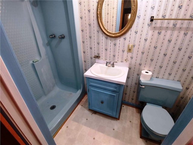 bathroom with vanity, a shower, and toilet