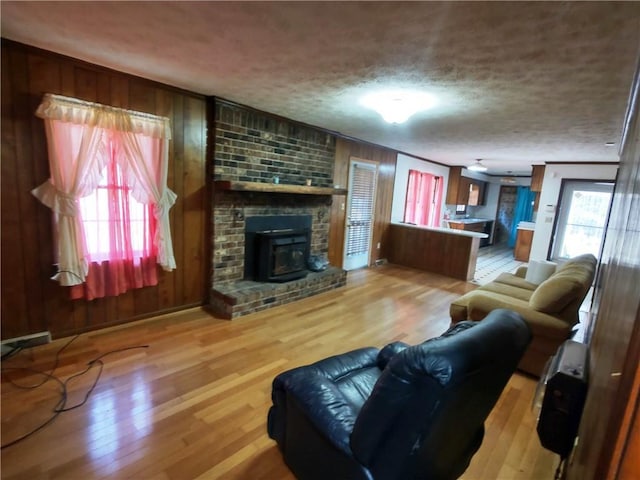 living room with a textured ceiling and light wood-type flooring