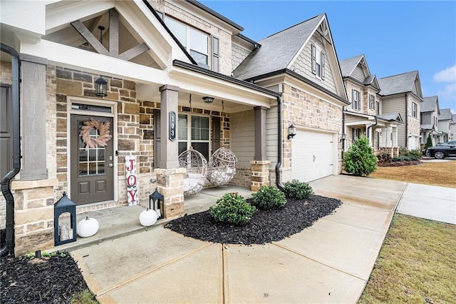 view of exterior entry with a porch and a garage