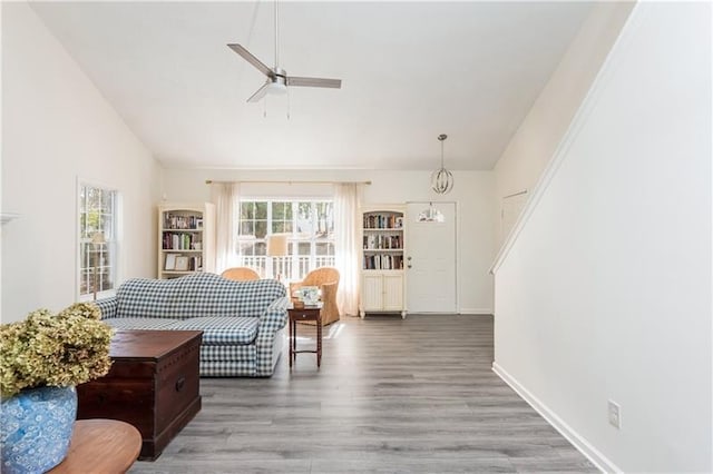 living room with hardwood / wood-style flooring and ceiling fan