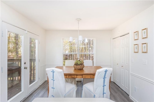 dining room with dark hardwood / wood-style flooring and a notable chandelier