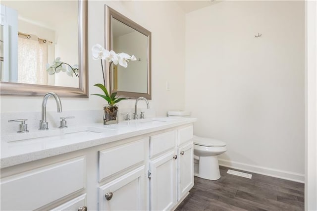 bathroom featuring hardwood / wood-style floors, vanity, and toilet