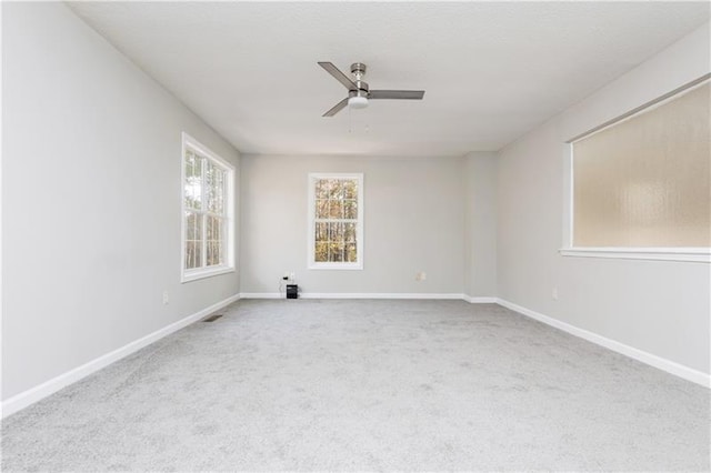 empty room with ceiling fan and carpet