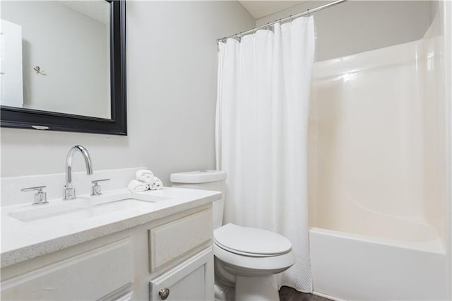 full bathroom featuring hardwood / wood-style floors, vanity, shower / tub combo, and toilet