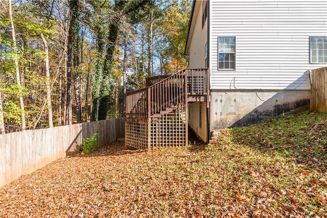 view of property exterior with a wooden deck