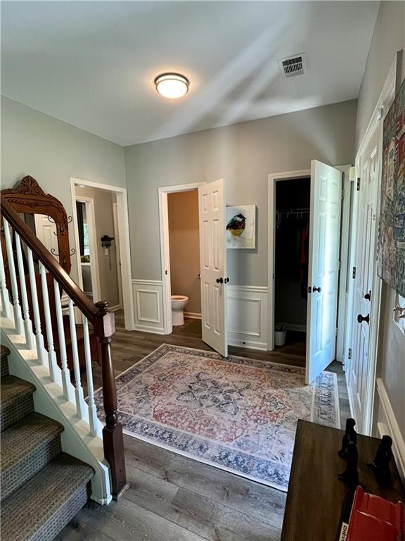 2278 Traywick Chase, Alpharetta, GA 30004 - interior space featuring stairs, a decorative wall, wood finished floors, visible vents, and wainscoting