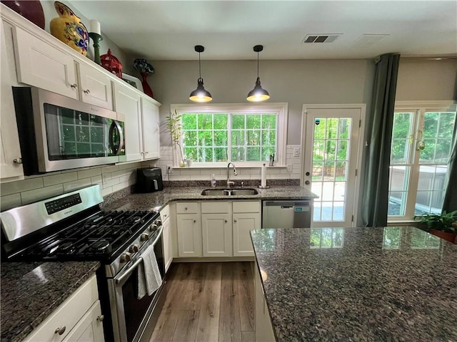 2278 Traywick Chase, Alpharetta, GA 30004 - kitchen with a sink, stainless steel appliances, wood finished floors, visible vents, and white cabinetry