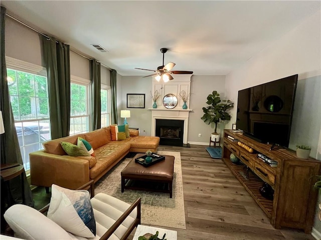 2278 Traywick Chase, Alpharetta, GA 30004 - living area with a ceiling fan, a fireplace with raised hearth, baseboards, visible vents, and wood finished floors