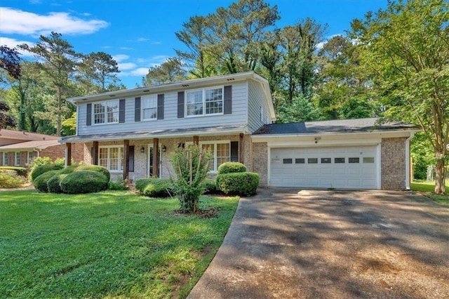 view of front of house with a front yard, brick siding, driveway, and an attached garage