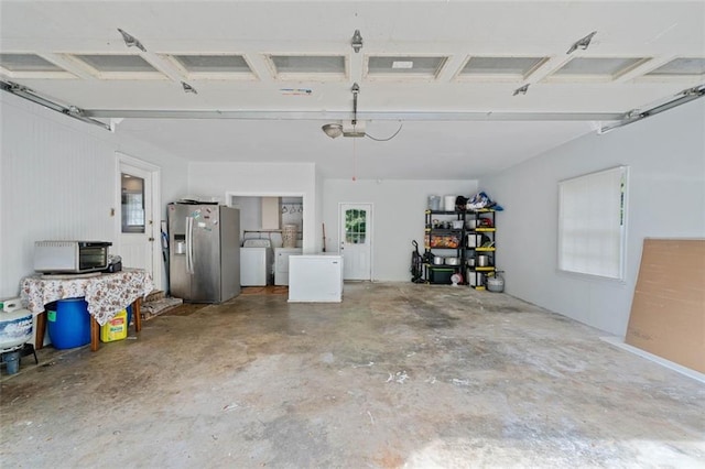 garage with washer / clothes dryer and stainless steel fridge with ice dispenser