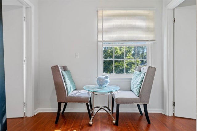 living area featuring baseboards and wood finished floors