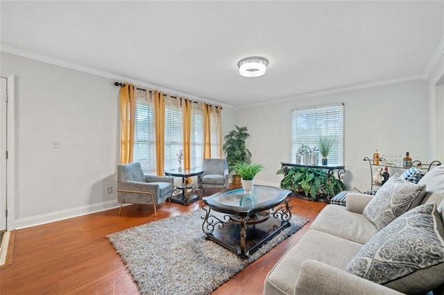 living area featuring crown molding, baseboards, and wood finished floors