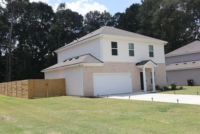 view of front of property with a garage and a front lawn