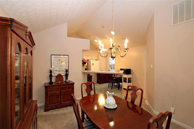 dining space featuring visible vents, a notable chandelier, a textured ceiling, carpet flooring, and vaulted ceiling