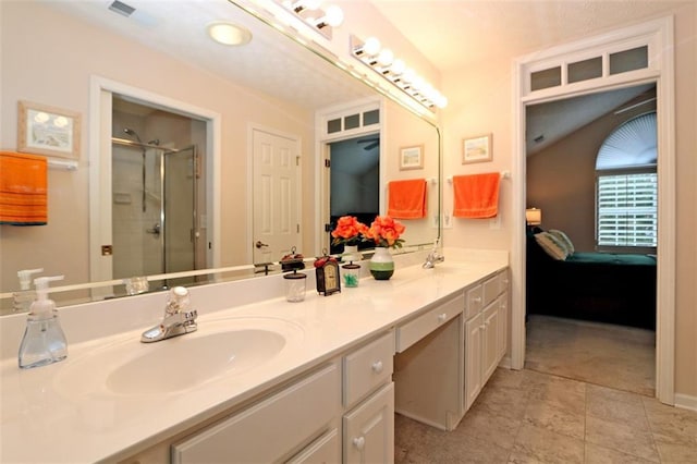 ensuite bathroom featuring a sink, double vanity, ensuite bath, and a shower stall