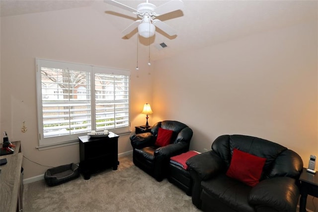 living area featuring visible vents, baseboards, ceiling fan, lofted ceiling, and carpet flooring