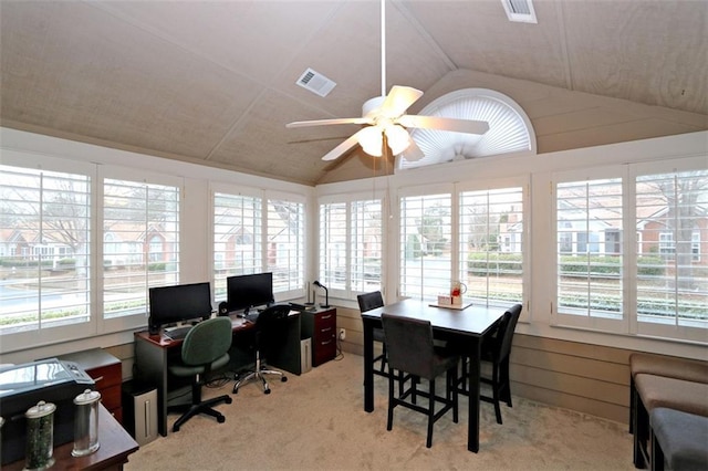 interior space with lofted ceiling, light colored carpet, and visible vents