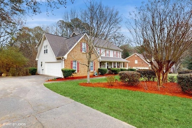 view of front of property featuring a garage and a front lawn