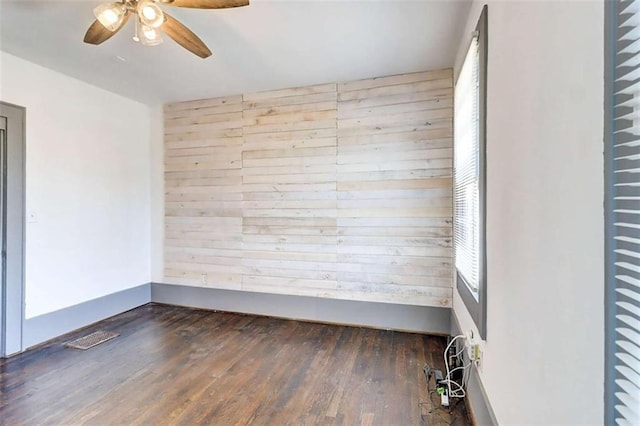 1497 Rogers Ave, Atlanta, GA 30310 - unfurnished room featuring wooden walls, a ceiling fan, and wood finished floors