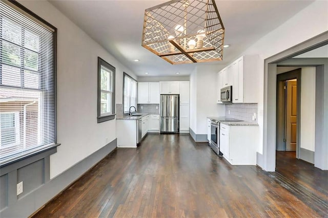 1497 Rogers Ave, Atlanta, GA 30310 - kitchen featuring stainless steel appliances, a chandelier, dark wood-type flooring, decorative backsplash, and recessed lighting