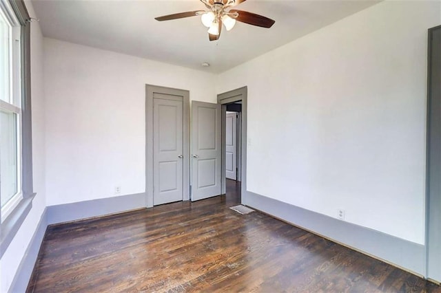 1497 Rogers Ave, Atlanta, GA 30310 - unfurnished bedroom featuring wood finished floors, multiple windows, and ceiling fan