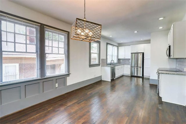 1497 Rogers Ave, Atlanta, GA 30310 - kitchen featuring appliances with stainless steel finishes, decorative backsplash, dark wood-style floors, white cabinets, and recessed lighting