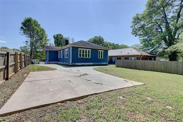1497 Rogers Ave, Atlanta, GA 30310 - back of property with a patio area, a fenced backyard, and a chimney