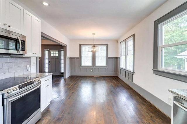 1497 Rogers Ave, Atlanta, GA 30310 - kitchen featuring appliances with stainless steel finishes, healthy amount of natural light, white cabinetry, wainscoting, and recessed lighting