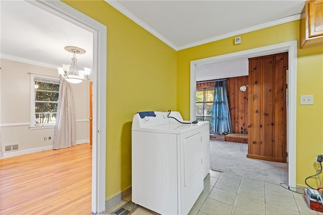 2081 Dodson Dr SW, Atlanta, GA 30311 - washroom with washer / clothes dryer, a chandelier, crown molding, baseboards, and light carpet