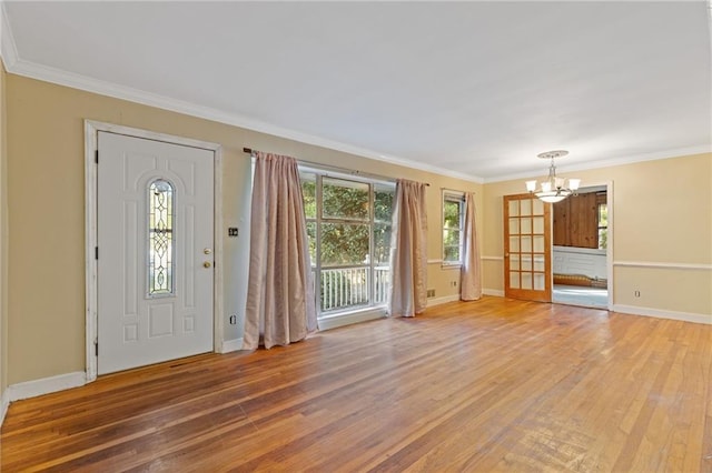 2081 Dodson Dr SW, Atlanta, GA 30311 - foyer entrance featuring a chandelier, light wood-type flooring, baseboards, and ornamental molding