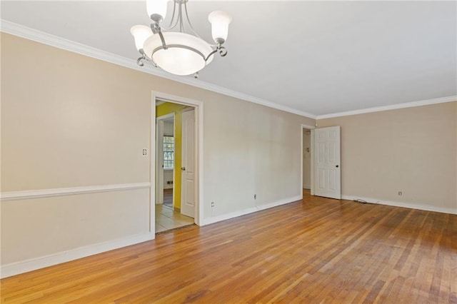 2081 Dodson Dr SW, Atlanta, GA 30311 - spare room with light wood-type flooring, ornamental molding, baseboards, and a chandelier