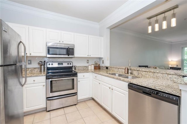 kitchen featuring appliances with stainless steel finishes, a sink, light tile patterned flooring, crown molding, and white cabinets