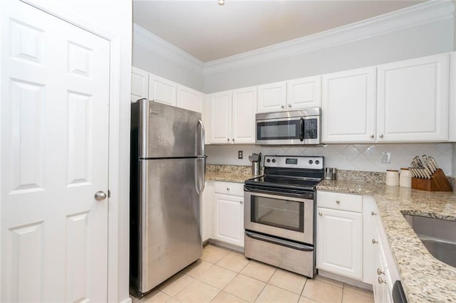 kitchen with appliances with stainless steel finishes, crown molding, white cabinets, light tile patterned floors, and light stone counters