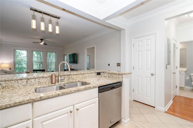 kitchen with dishwasher, a sink, white cabinets, light stone countertops, and light tile patterned flooring