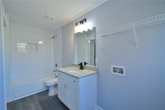 unfurnished bedroom with ceiling fan, ensuite bathroom, a barn door, and carpet floors