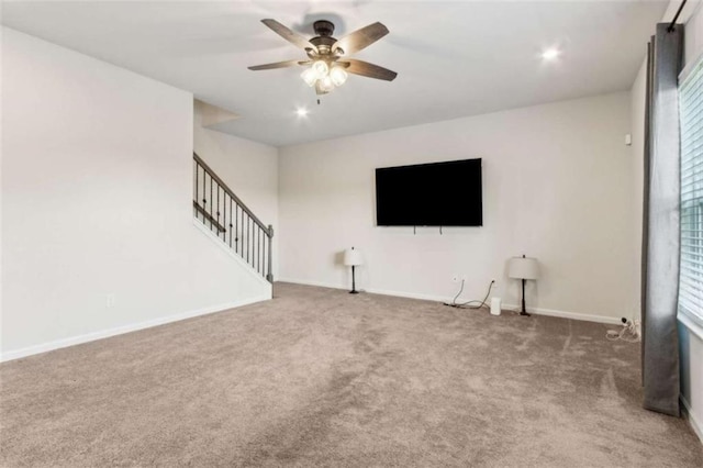 1130 Lyndhurst Ln, Bethlehem, GA 30620 - unfurnished living room featuring carpet floors, ceiling fan, stairway, healthy amount of natural light, and recessed lighting
