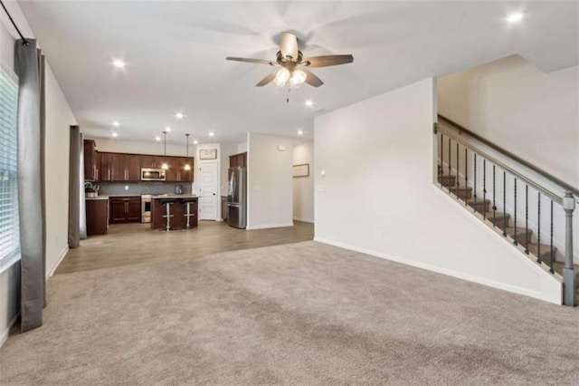 1130 Lyndhurst Ln, Bethlehem, GA 30620 - unfurnished living room with light carpet, ceiling fan, recessed lighting, and stairs