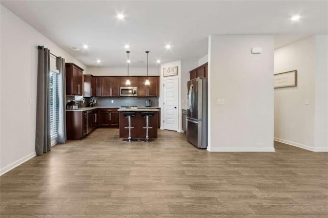 1130 Lyndhurst Ln, Bethlehem, GA 30620 - kitchen featuring stainless steel appliances, a center island, light wood-style flooring, light countertops, and tasteful backsplash