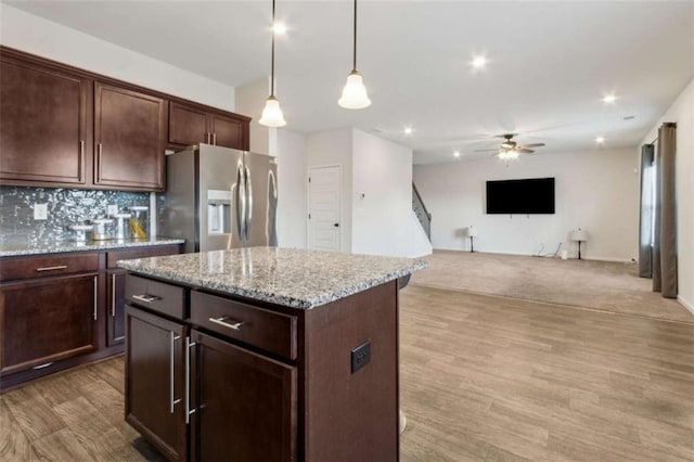 1130 Lyndhurst Ln, Bethlehem, GA 30620 - kitchen with stainless steel refrigerator with ice dispenser, a ceiling fan, hanging light fixtures, tasteful backsplash, and dark brown cabinetry