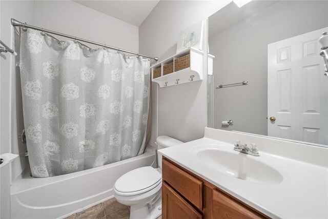 full bathroom with tile patterned flooring, vanity, toilet, and shower / bathtub combination with curtain