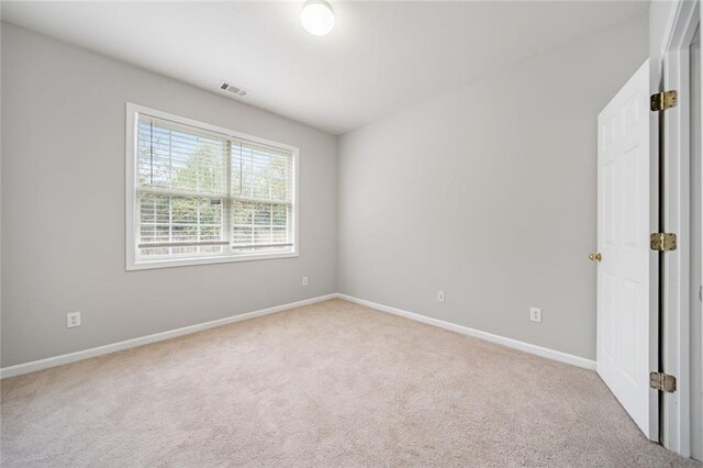 unfurnished room with light carpet