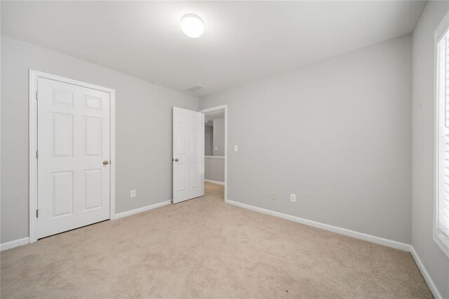 unfurnished bedroom with light carpet